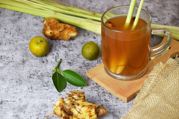 Healthy hot red ginger drink with a mixture of lemon and honey