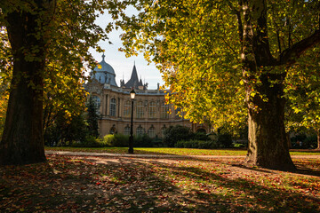 Budapest City Park (varosliget in Hungarian) during a beautiful autumn day, with orange vivid trees and lake in the middle of this park from Hungary. Sunny autumn day. Travel to Budapest.