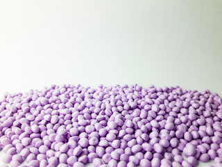 Lavender masterbatch granules on white background,color pigment carrier polymer in plastic industry,suitable for plastic company catalogue
