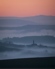 A distant, minimalist rural village with a few thin lines defining it, soft smoke billowing, and a tranquil environment. 