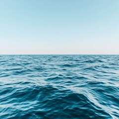 Calm ocean surface under a clear blue sky.