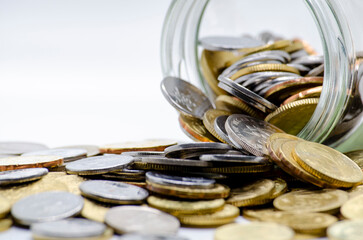 Gold coins in a jar with white background representing business, investment or any monetary...