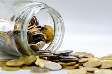 Gold coins in a jar representing business, investment or any monetary concept. Customizable space...