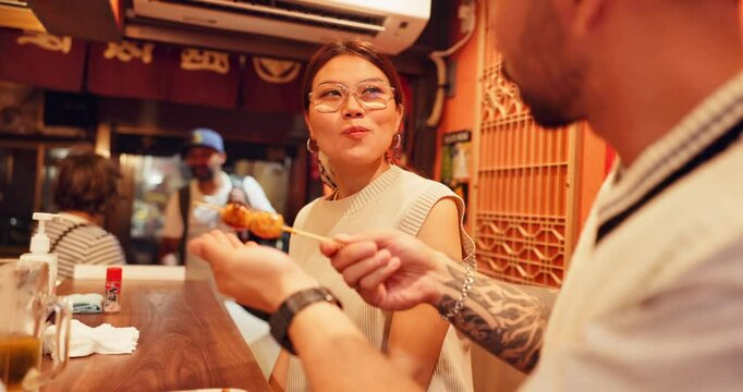 Love, eating and Japanese couple in restaurant, night and conversation with healthy meal. Yakitori, man and woman with date, romance and relationship with marriage, evening and valentines day