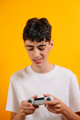 A teenager holds a controller to play video games.