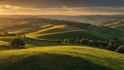 Fototapeta premium Rolling green hills at sunset, with a village nestled in the valley.