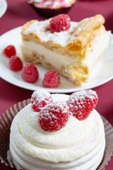 desserts with raspberries on white plates on the table