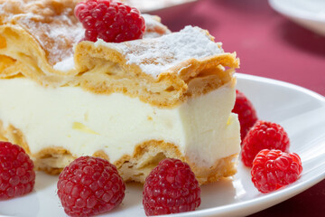 desserts with raspberries on white plates on the table