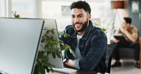 Computer, smile and web development with man in creative workplace for coding or design....
