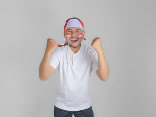 Naklejka premium Excited young Asian men celebrate Indonesian independence day on 17 August isolated over white background