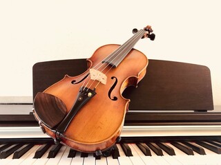 Violin on top of piano keyboard background with copy space for music concept