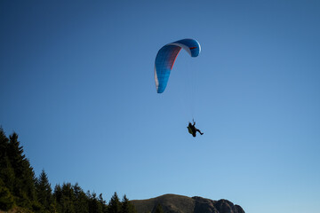 Paragliding in Ciucas mountains, Romania, during autumn season