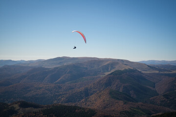 Paragliding in Ciucas mountains, Romania, during autumn season