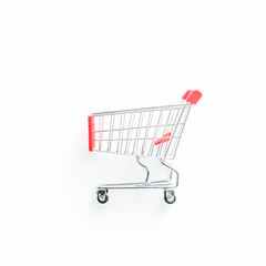 Empty shopping cart with red handle on a white background