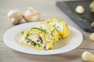 baked potato roll with cottage cheese filling with garlic and mushrooms, on a light wooden table