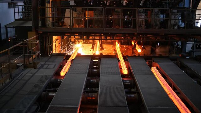 Steel Billets at Torch Cutting. Iron foundry. Continuous casting machine. Production of steel billets. Continuous casting machine with blow torch working. hot steel on conveyor in steel mill.