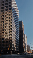 Downtown Ottawa, Canada – A view of modern high-rise buildings bathed in sunlight, showcasing urban architecture and bustling city life under a clear blue sky