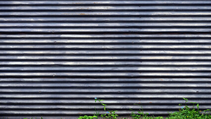Old corrugated iron wall painted gray, dirty