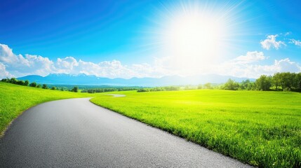 Serene Landscape with Winding Road, Lush Green Grass, Bright Sunlight, and Majestic Mountains in the Background Under a Clear Blue Sky
