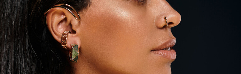 A stunning African American woman highlights her jewellery in a studio.