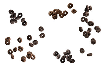 Chocolate rings cereal spill out into a bowl. Breakfast.