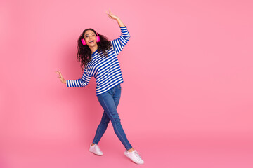 Full body portrait of nice young girl dance headphones empty space isolated on pink color background