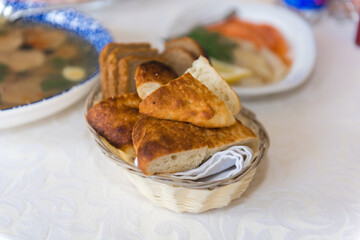 A bread plate is on the table. A hearty yeast snack.