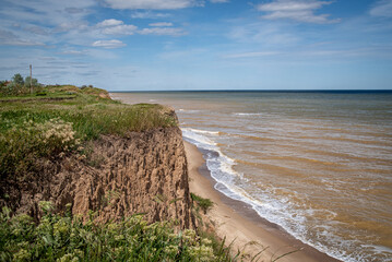 Seascape of a cliff by the sea, on a warm sunny day
