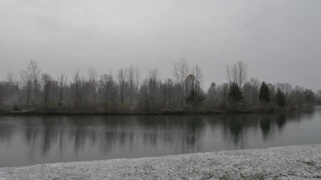 Birds on a lake during a snow flurry