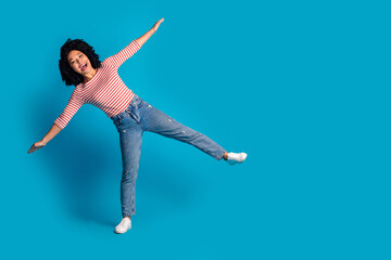 Obraz premium Photo of crazy funky cheerful girl wear trendy clothes going string empty space isolated on blue color background
