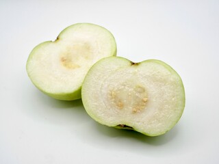 Close up image of half-cut green guava isolated on a white background. Fresh fruit with alot of vitamin C
