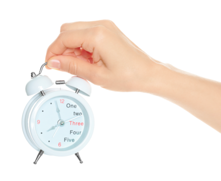 Woman hand holds white Alarm Clock, isolated on transparent background, time and home things concept