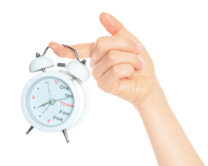 Woman hand holds white Alarm Clock, isolated on transparent background, time and home things concept