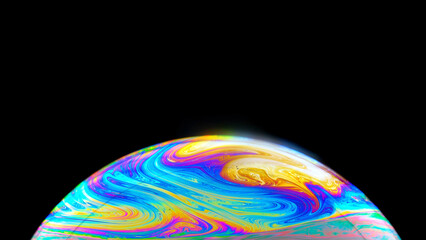 Soap bubble and its beautiful iris shimmers in different colors, close-up