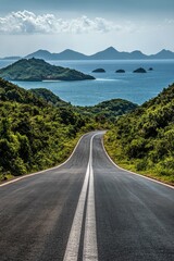 Obraz premium Serene coastal road leading to distant islands under a vibrant sky