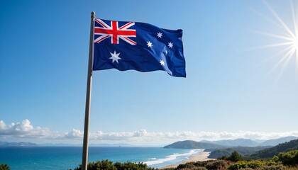 Australian flag waving proudly against a scenic coastline with ocean and mountains in the background