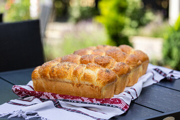 Home made traditional Romanian bread. Close up photo with bread and slices of bread cooked in...