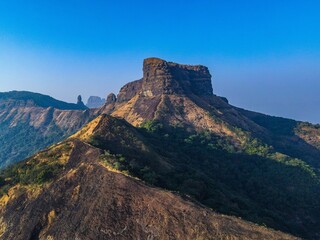 Mountain valley with lush green grass and shrubbery