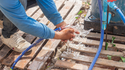 Workers wash their hands after finishing work. In the evening at the construction site