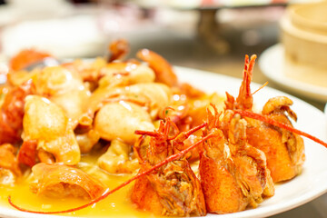 a plate of shrimp with a yellow sauce on it