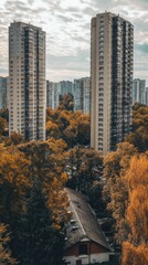 Obraz premium Urban Skyline Meets Autumn Colors in a Tranquil Setting of High-Rises Surrounded by Lush Foliage During a Cloudy Afternoon