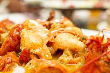 a plate of food with crab and sauce on it.