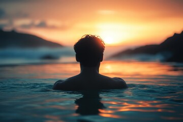 Man Silhouetted in Ocean Water at Sunset