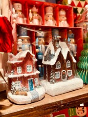 Decorative gingerbread houses and toy nutcrackers sit on a store counter