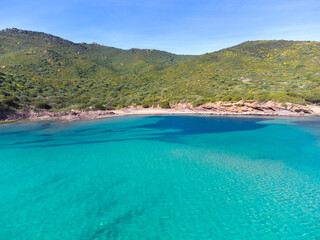 Turquoise water and green hills in Sardinia