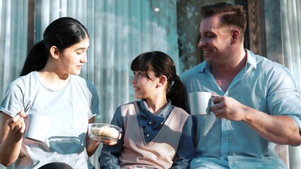 Lovely marriage couple and daughter picnic at outdoor terrace. Family using outdoor activity show love and care to strengthen good growth for child, strong family bond or relationship. Divergence.