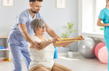 Senior health care and rehabilitation, physical therapist, nurse or sport instructor doing rubber...