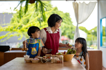 Mother is sharing a lime with her daughter while cooking in kitchen