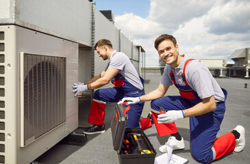 Portrait of a smiling electrician using tools and equipment, installing, maintaining, or repairing...