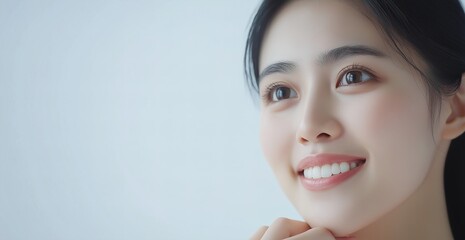 Close up photo of an Asian woman smiling. Teeth whitening and health concept.